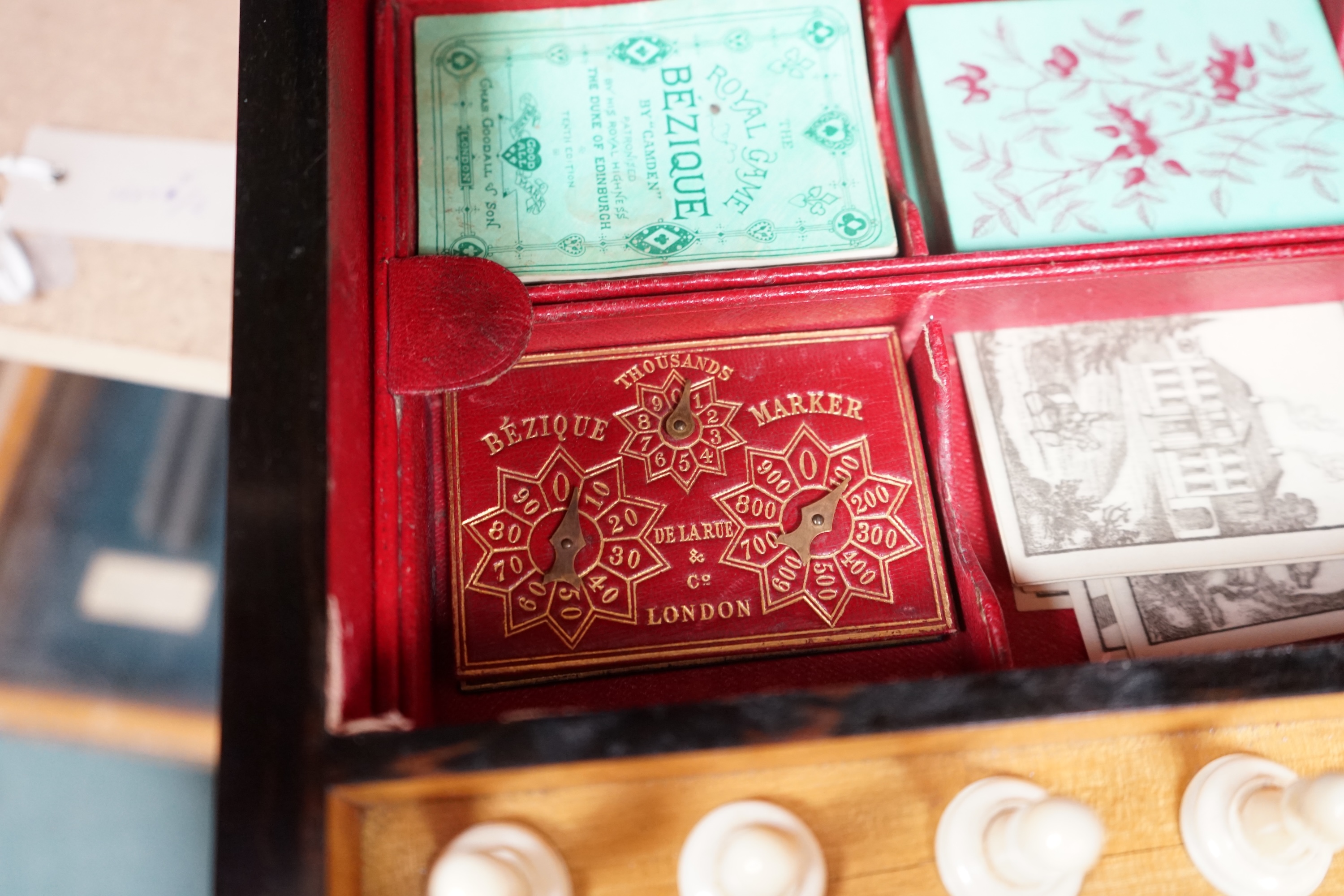 A Victorian coromandel games box with accessories, ivory chess pieces and counters, box 36cm wide x 19cm high. Condition - red interior leather worn and torn in places and box scratched, minor losses to chess pieces. CIT